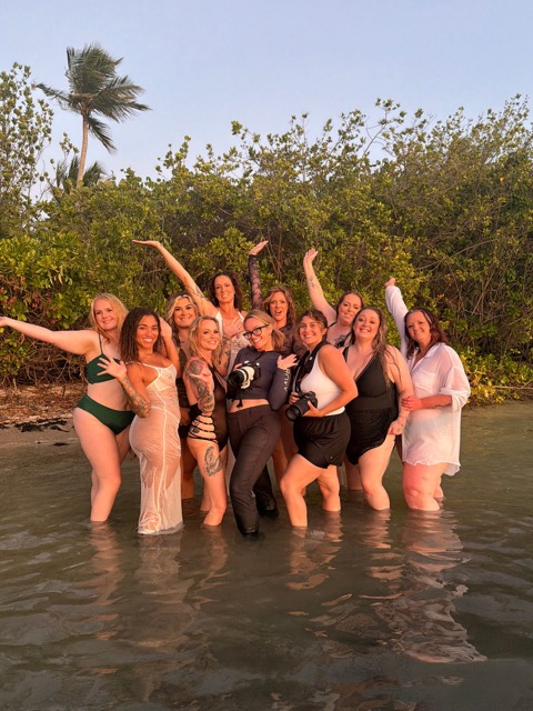Women and photographers together at a destination boudoir retreat in Puerto Rico at sunset