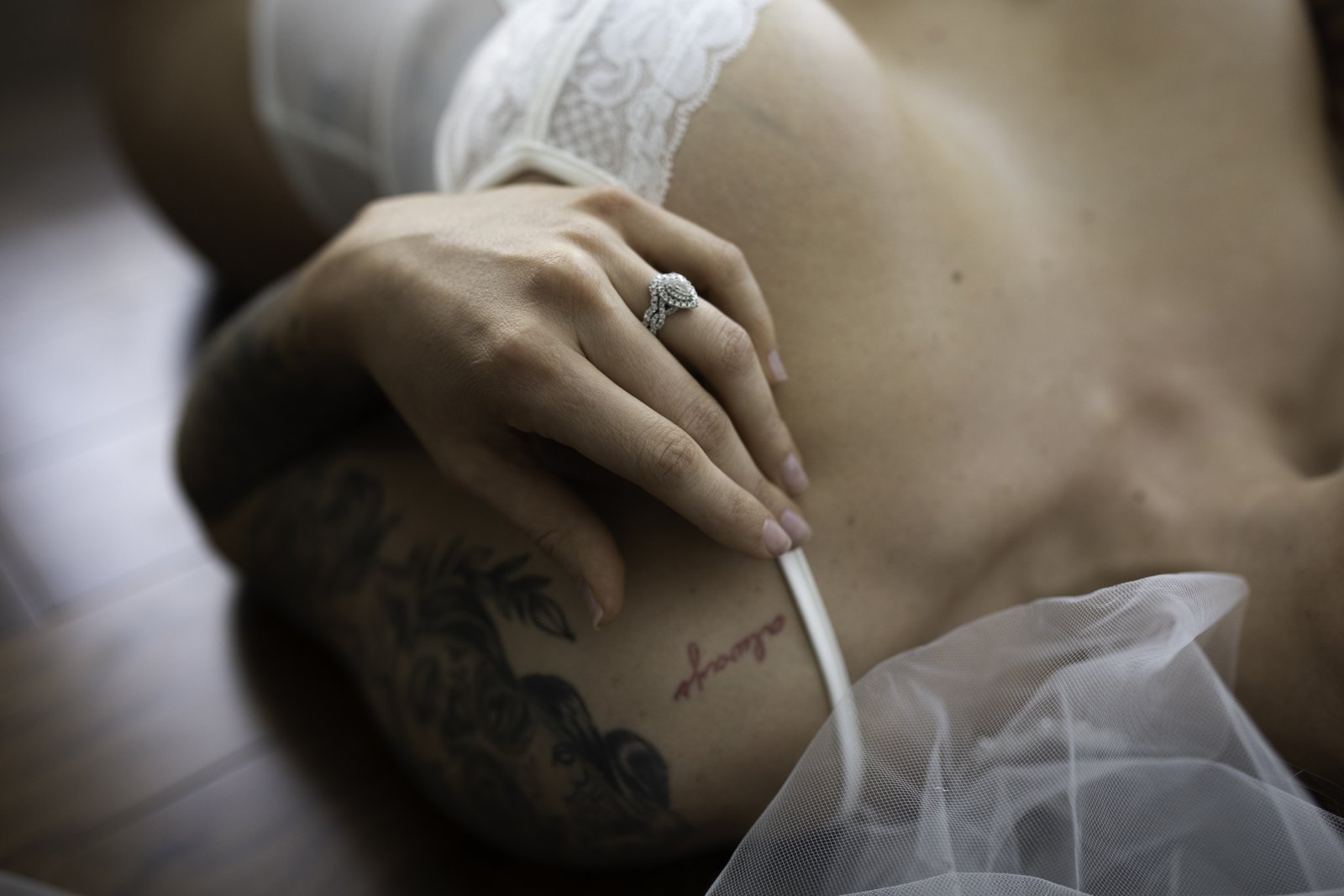 Bride to be in white lace with her engagement ring and veil at a Chicago bridal boudoir session by Bri Valiente Boudoir