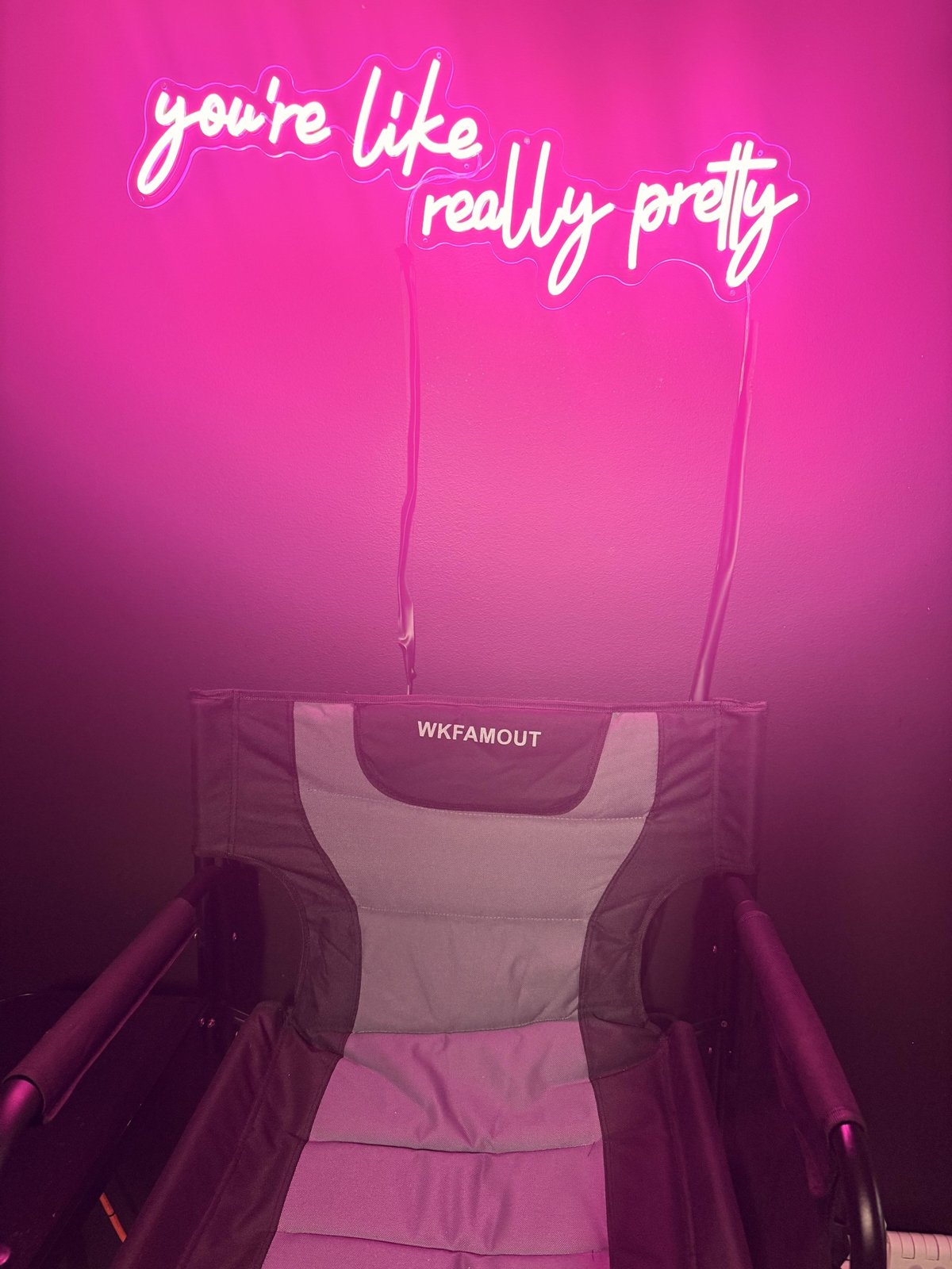 Glam chair under the you're like really pretty neon sign at Bri Valiente Boudoir