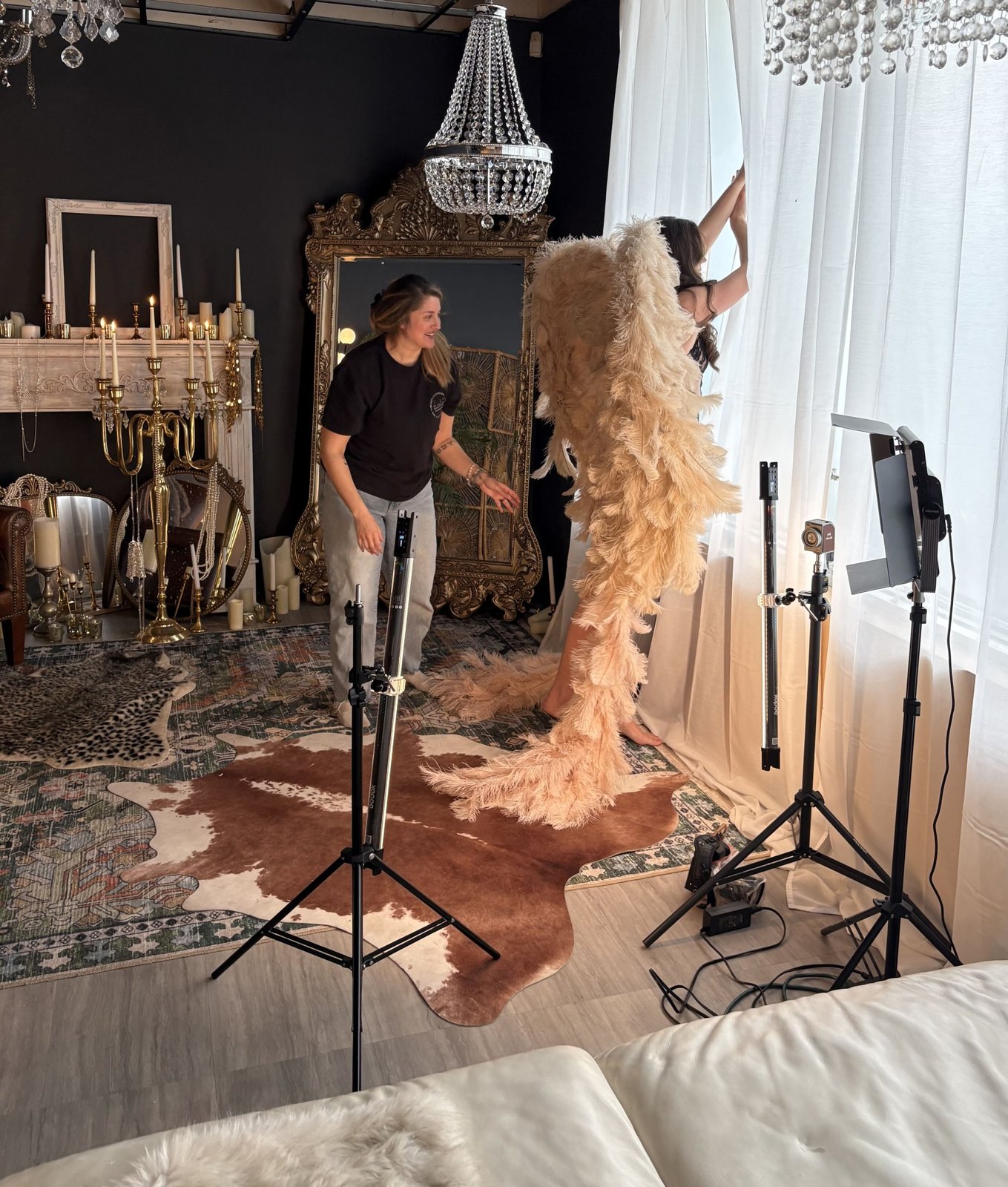 Bri Valiente directing a client in angel wings in her Chicago boudoir studio