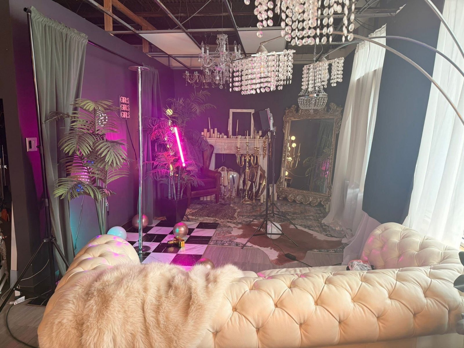 Neon lit boudoir set with checkered floor and chandeliers at the Chicago studio