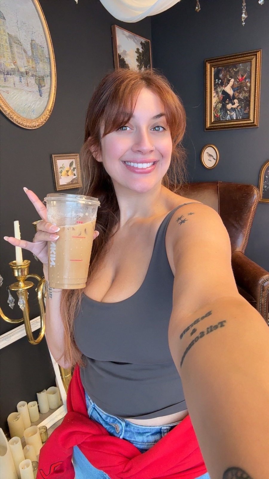 Bri Valiente taking a selfie with an iced coffee in her Chicago boudoir studio