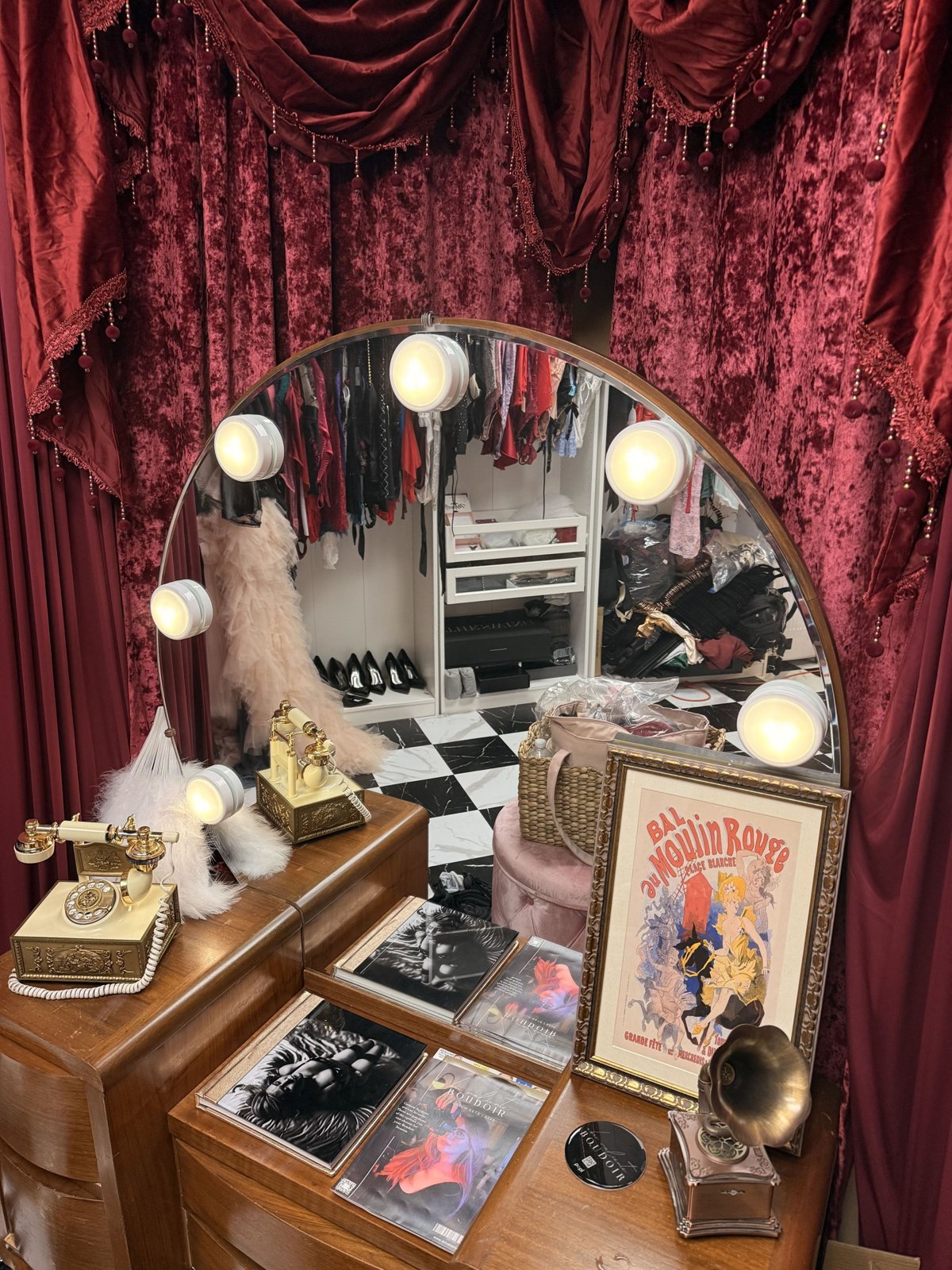 Glam vanity at Bri Valiente Boudoir with the client closet of robes and lingerie reflected in the mirror