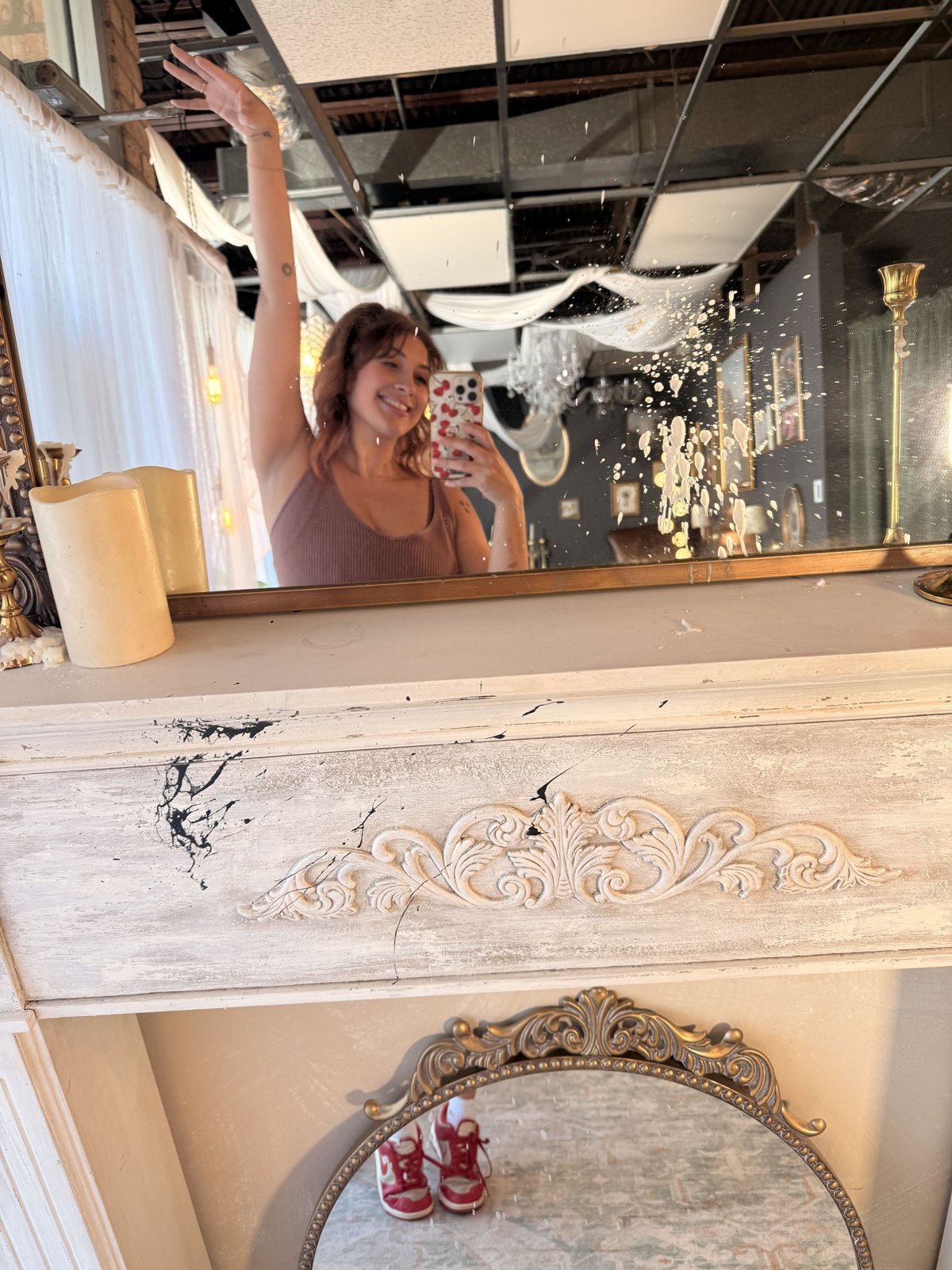 Bri Valiente waving in a mirror selfie in her Chicago boudoir studio