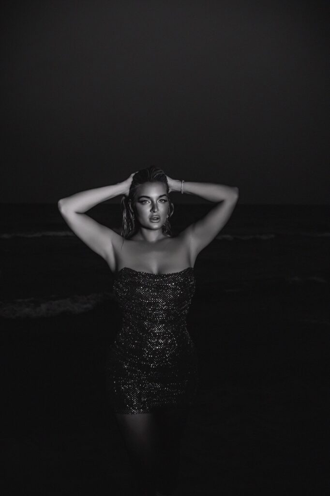 Chicago editorial boudoir shoot by Bri Valiente Boudoir featuring a woman in a sparkly dress on the Lake Michigan beach at night